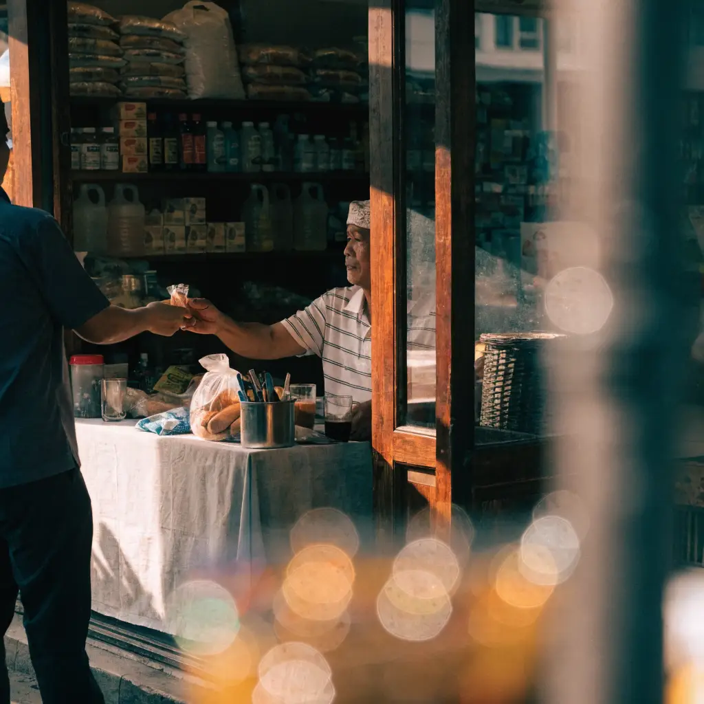 Malaysian retail shop owner serving a customer